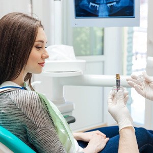 Dentist explaining dental implant treatment to patient