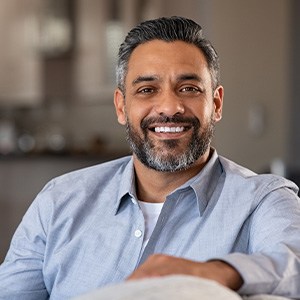 Man smiling while sitting on couch