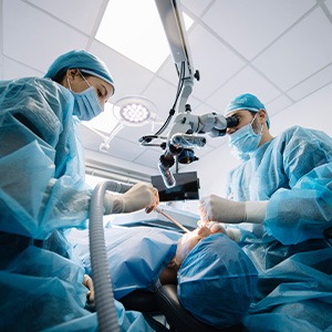 Dentists performing a dental implant surgery