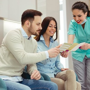 A dentist reviewing a patient’s dental insurance benefits with them