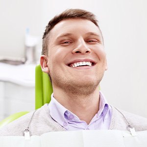 Smiling man sitting in dental office