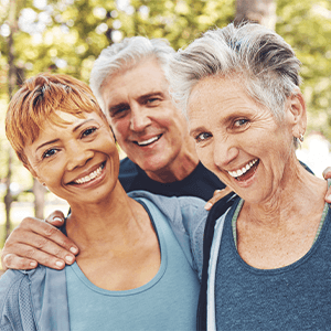 Diverse group of 4 seniors smiling together outside