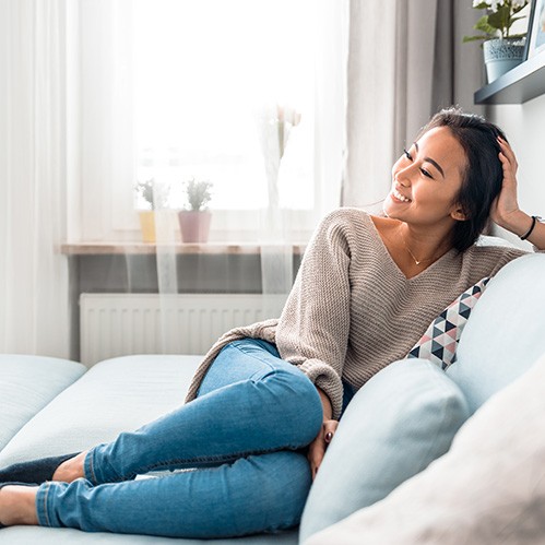 a woman resting on a couch 